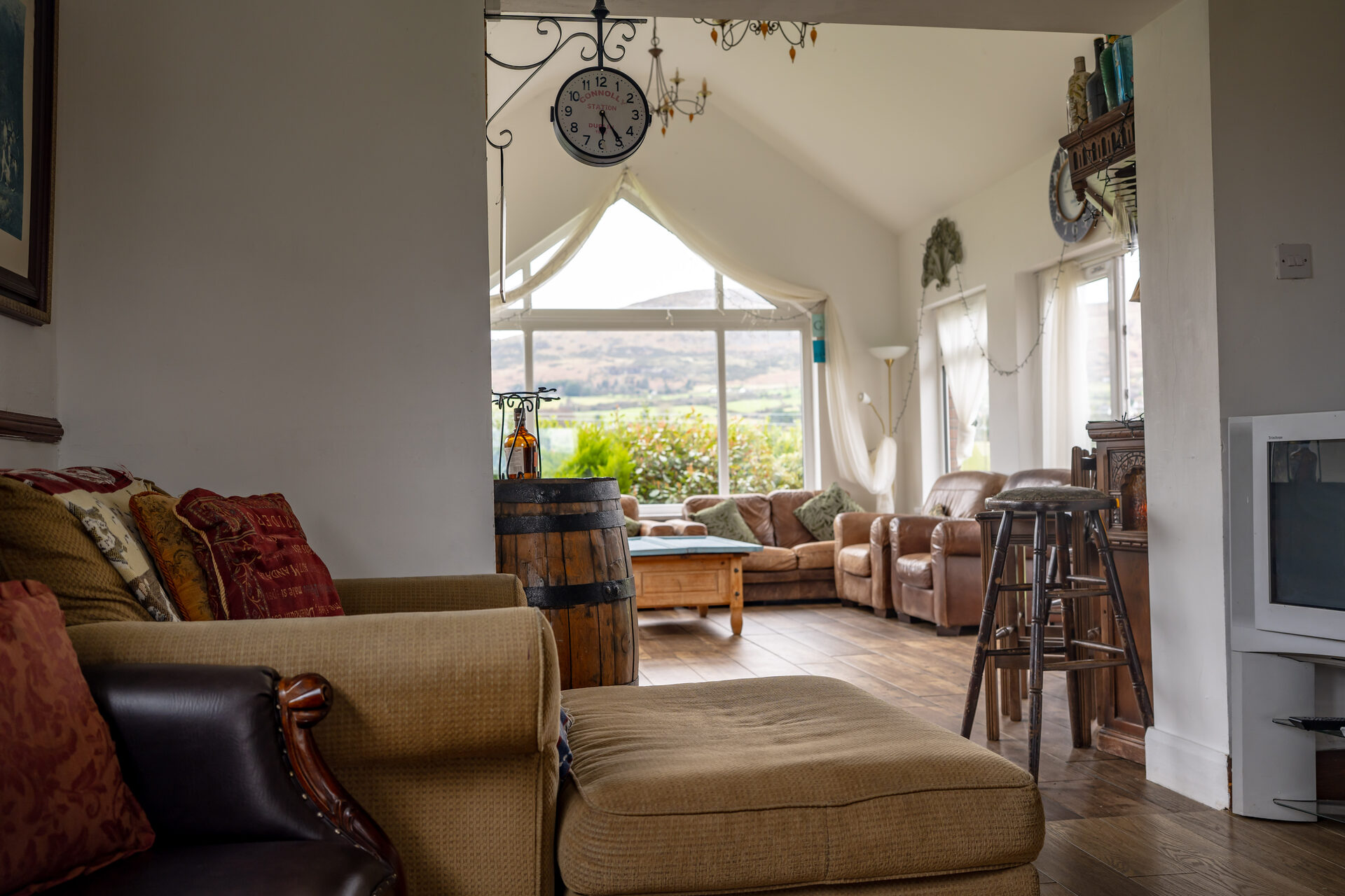 Stunning conservatory living room with mountain views
